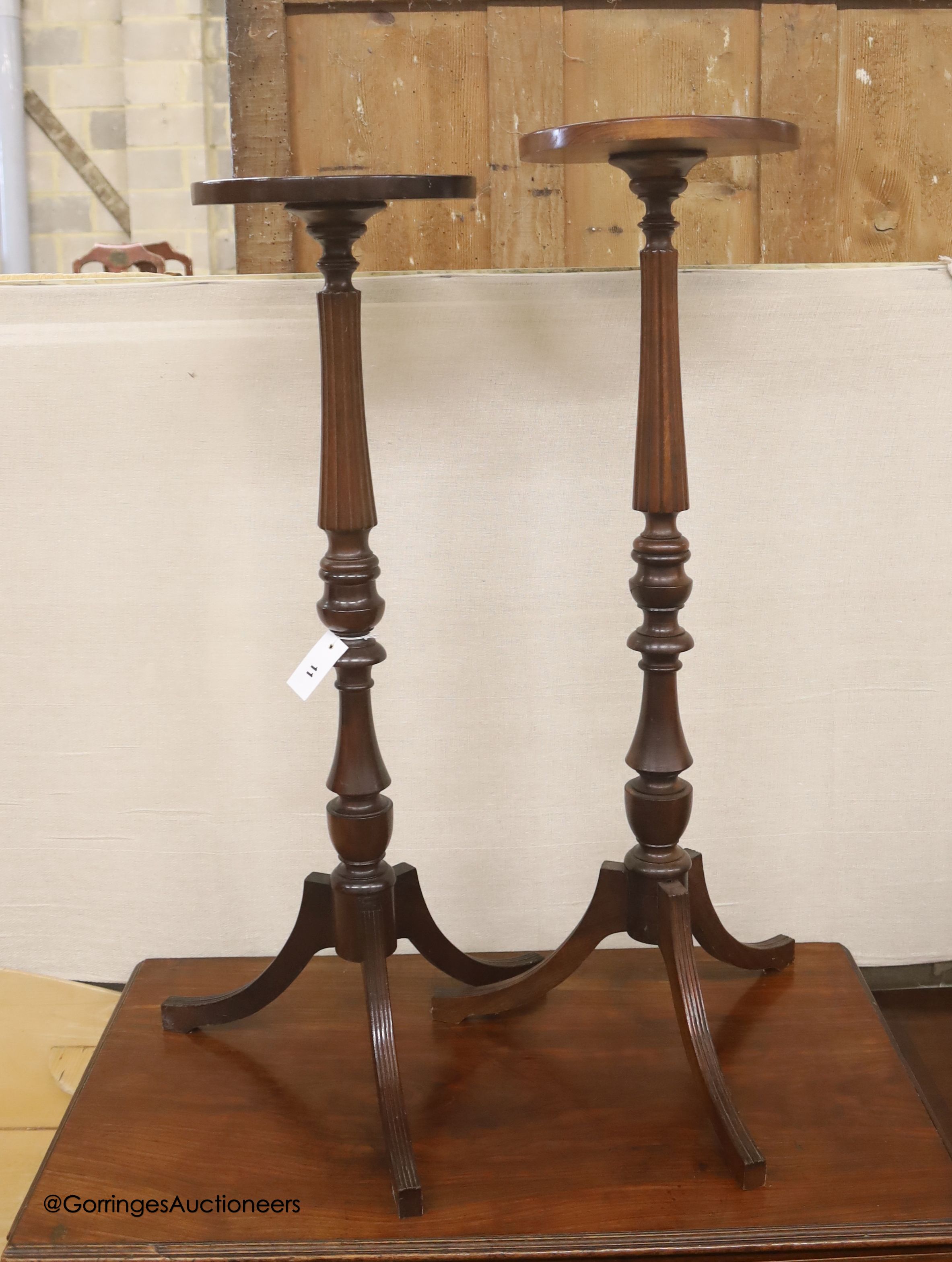 A near pair of reproduction mahogany torcheres, larger 100cm high